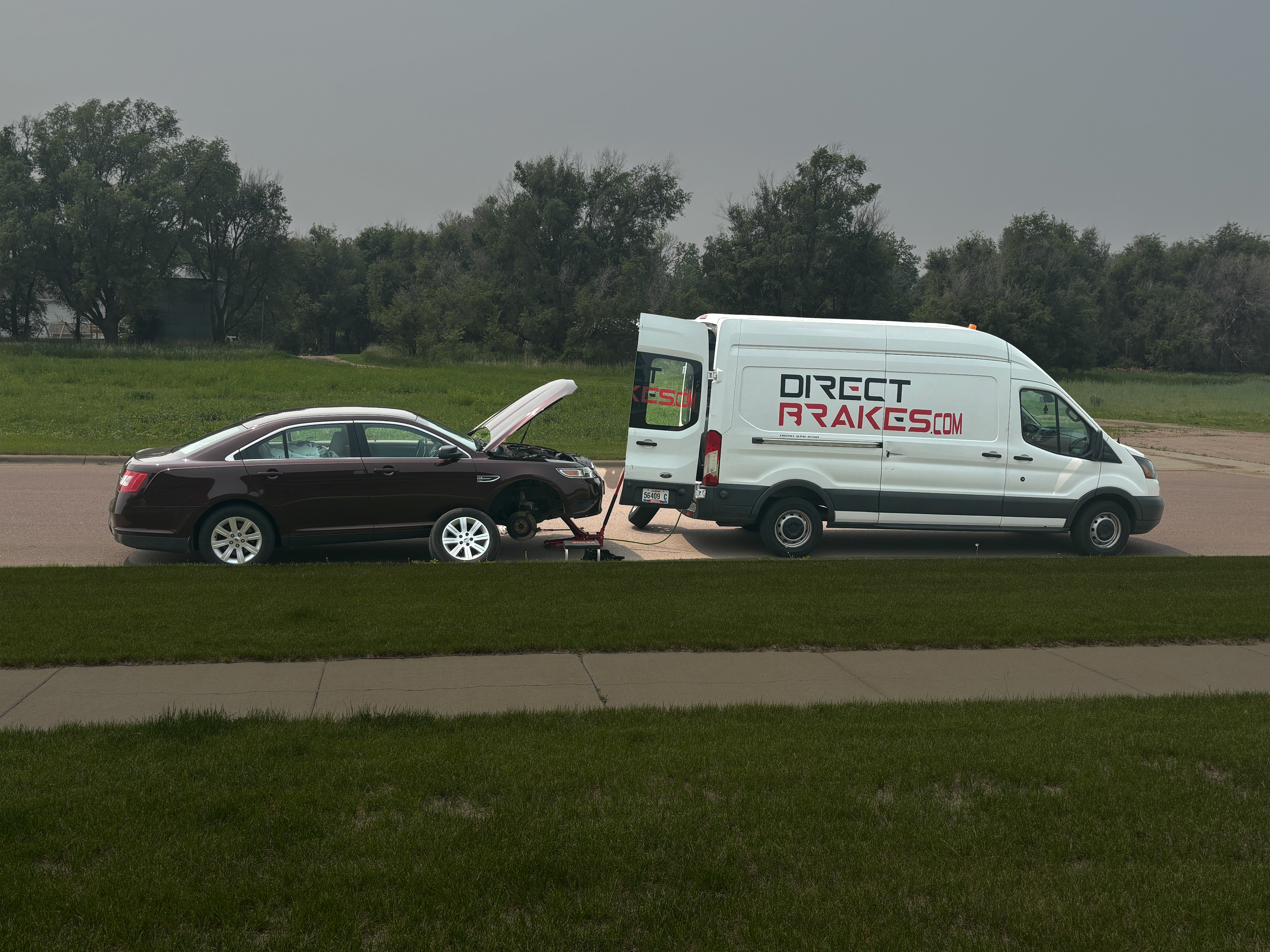 Technician replacing brake pads at customer's home in Sioux Falls