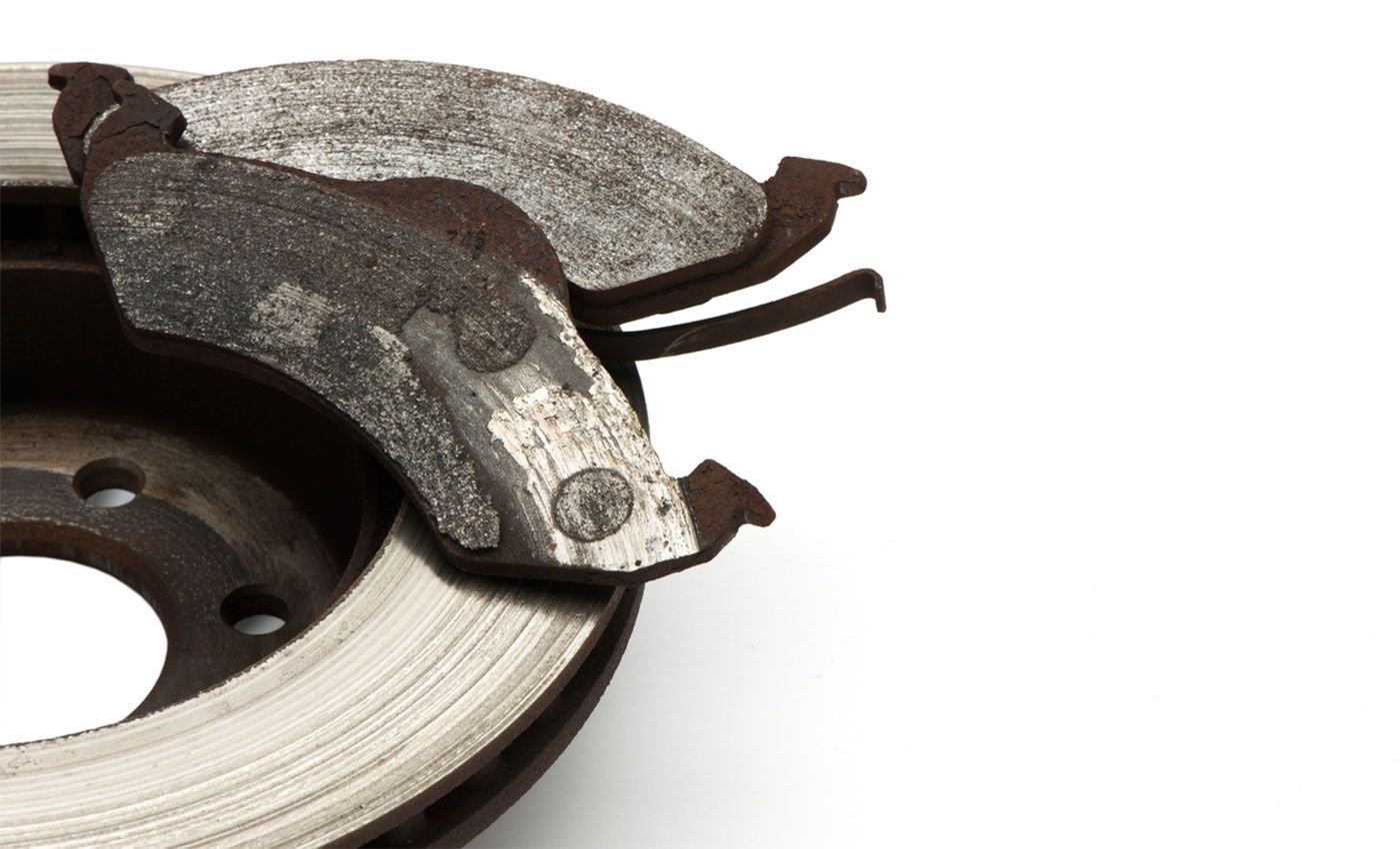 Photo showing how to measure brake pad thickness through wheel