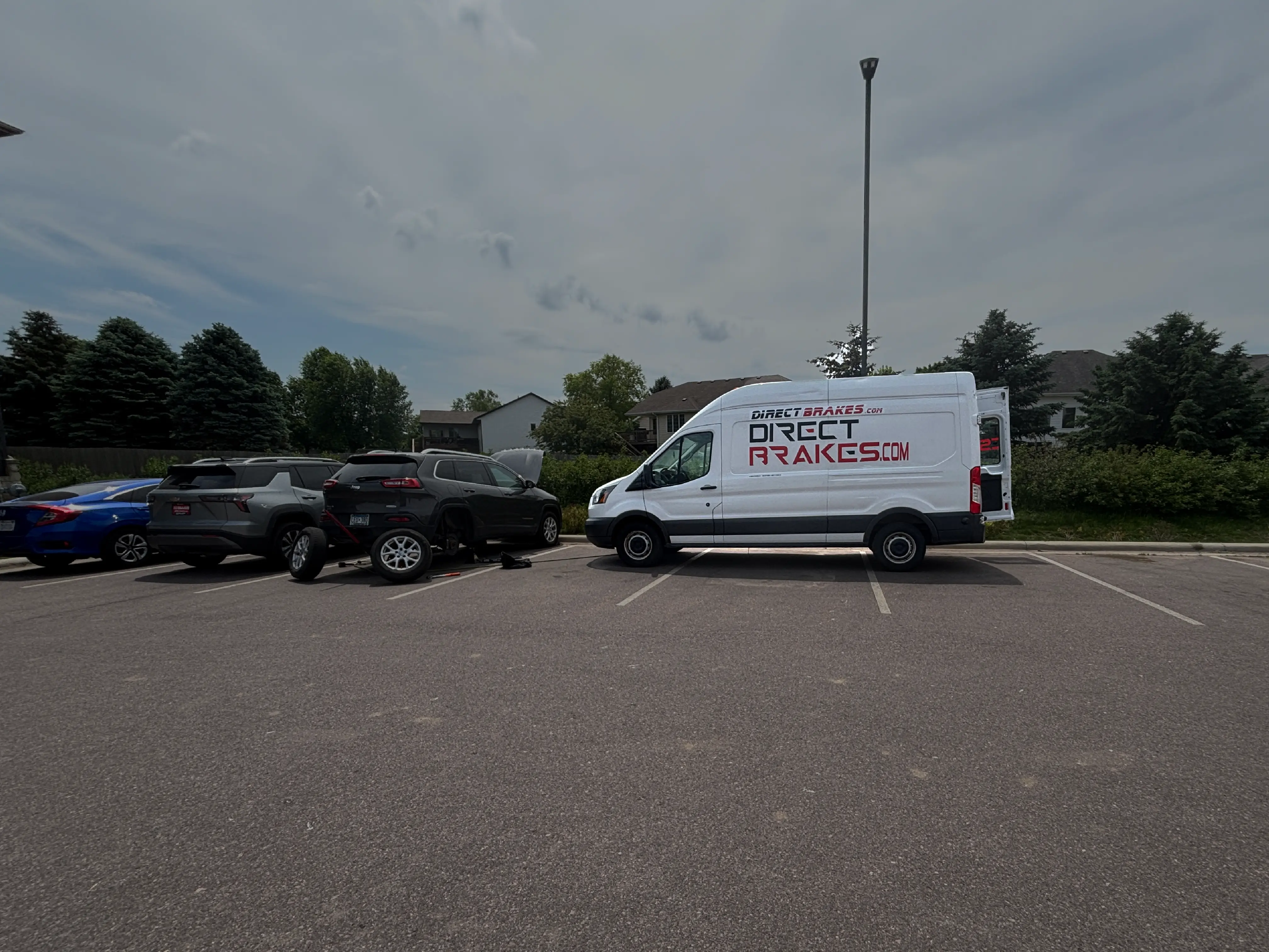 Mobile brake repair technician servicing vehicle in Sioux Falls