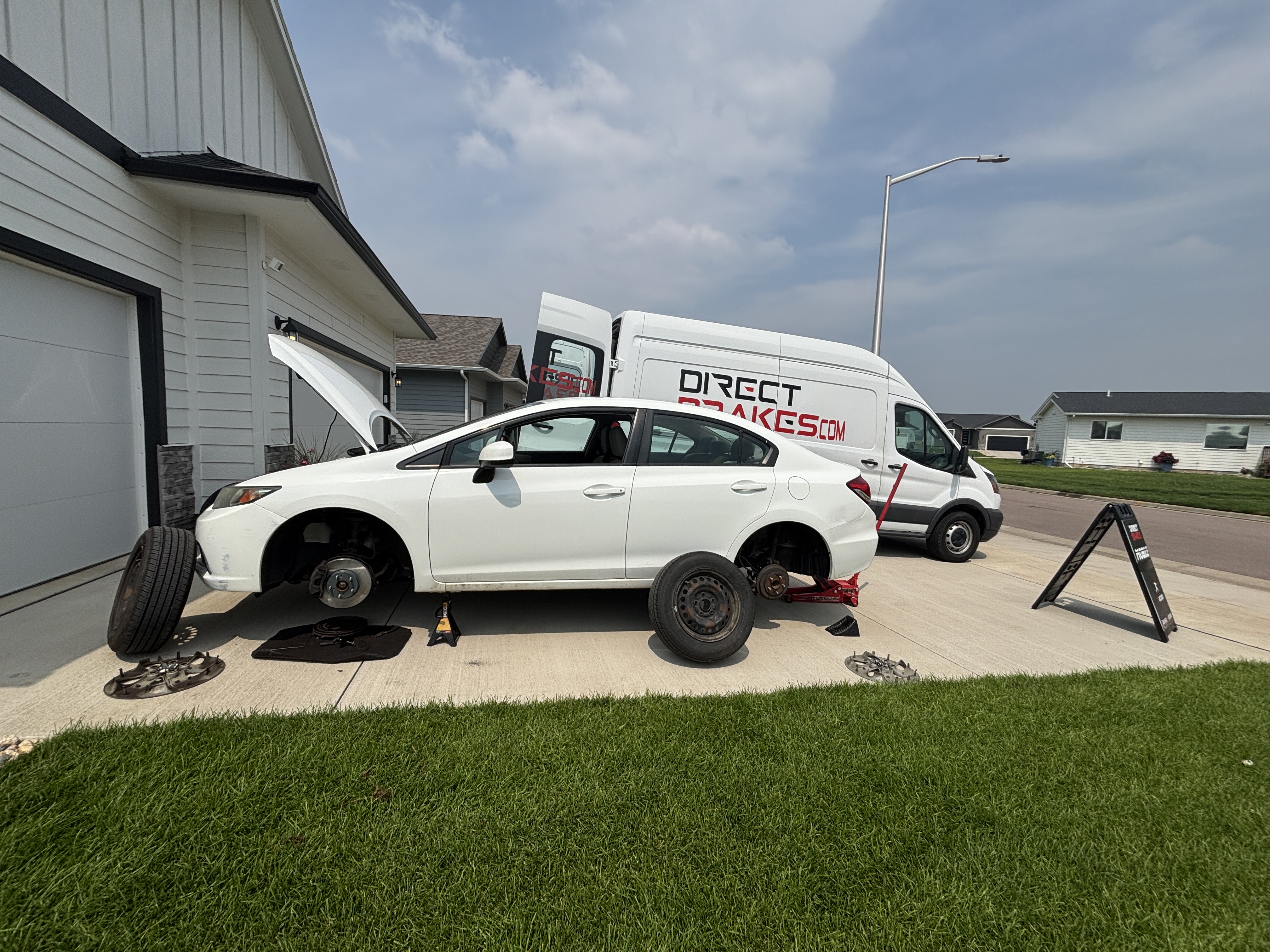 Mechanic performing affordable brake service in 57105 area